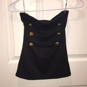 Black tube top with gold button.